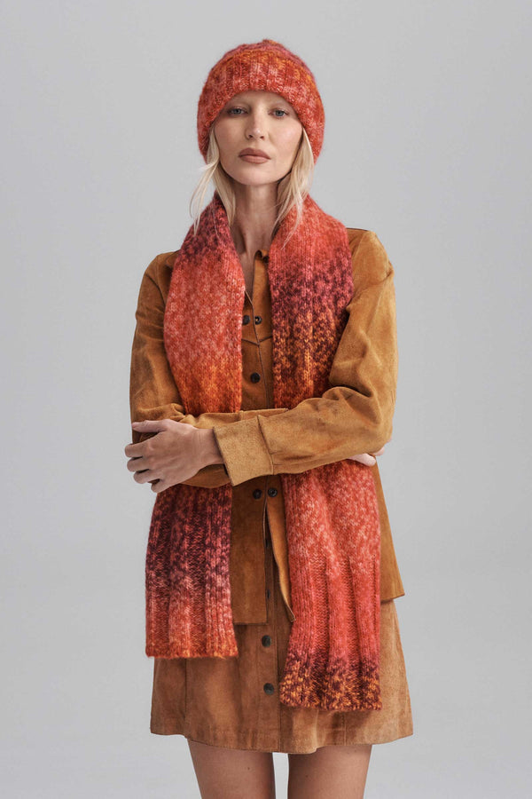Model wearing Kai Scarf in Flame color, showcasing variegated rib detail.