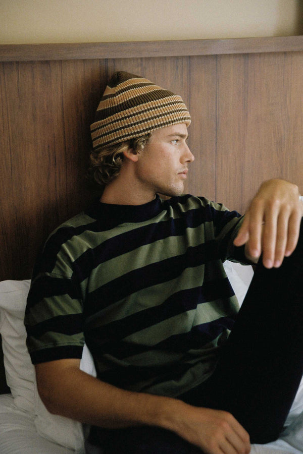 Model wearing Momo Beanie in Coffee Cola with striped shirt