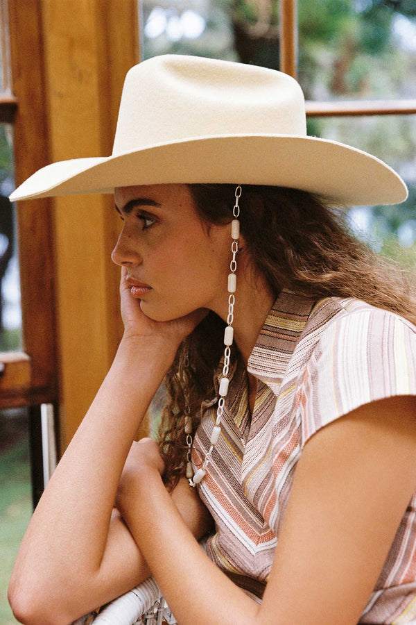 Model wearing a Ryder Cowboy hat in buttery yellow with a beaded chin strap