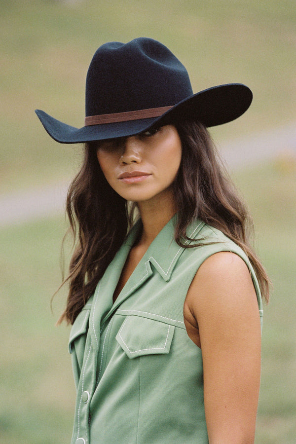 Model wearing the Wilder Cowboy black wool felt hat, showcasing its style and fit.