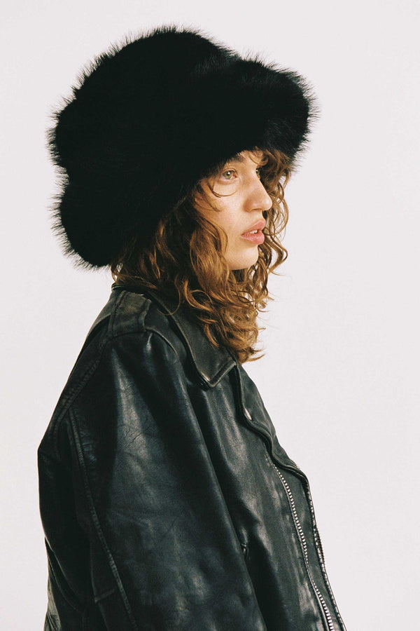Snuggle Bucket - Black faux-fur bucket hat on a model