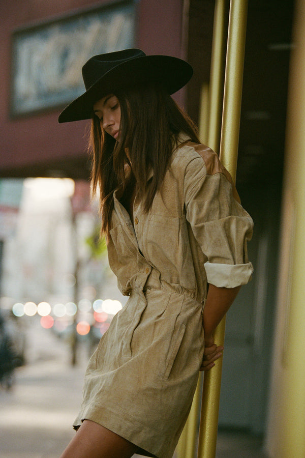 Model wearing The Ridge black wool felt cowboy hat in a city setting