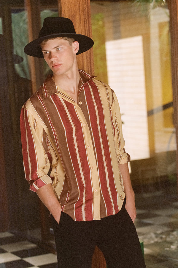 Model wearing the Diego black wool felt fedora hat with a striped shirt