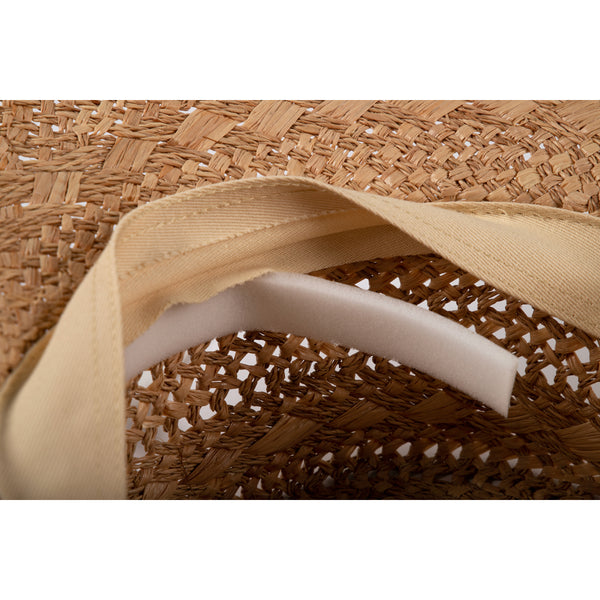 Interior view of a straw hat showing foam hat filler for snug fit.