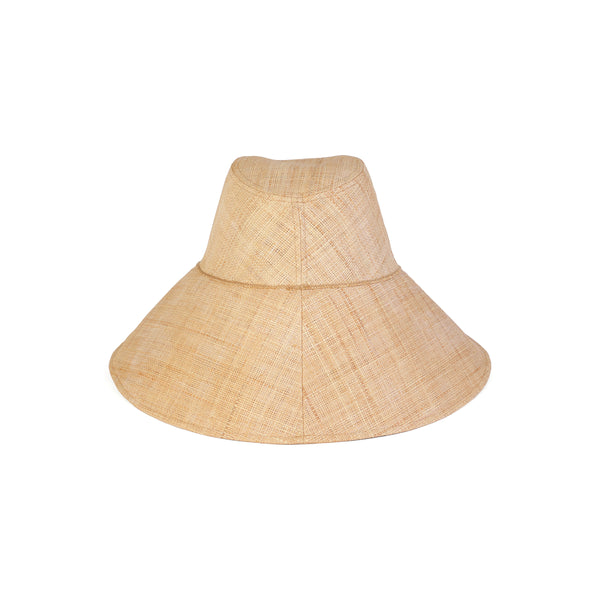 The Cove straw bucket hat in natural color, featuring a wide brim and dome shape.
