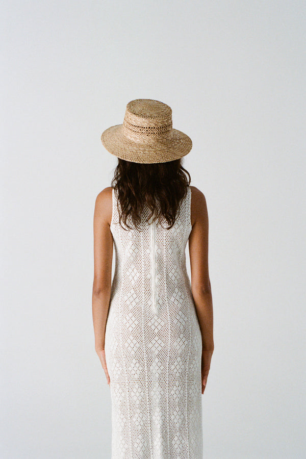 Model wearing Inca Bucket Wide straw hat, back view, with a white lace dress.
