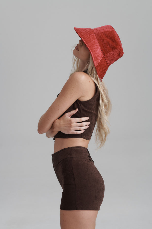 Model wearing a Vacay Bucket hat in red, showcasing its style and fit.