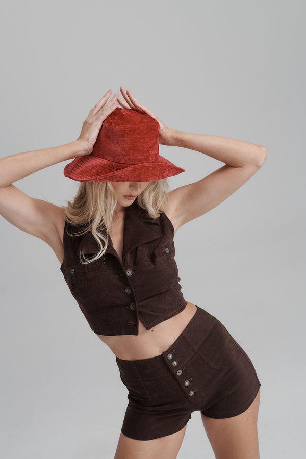 Model wearing a red Vacay Bucket hat with a brown outfit