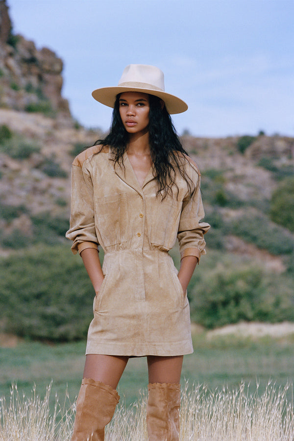 Model wearing The Mirage ivory wool felt fedora hat in a natural outdoor setting